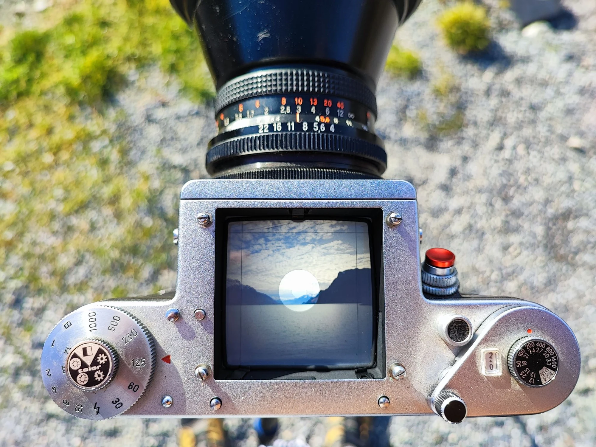 Pentacon Six medium format camera, viewed from above with a landscape visible in the waist-level finder
